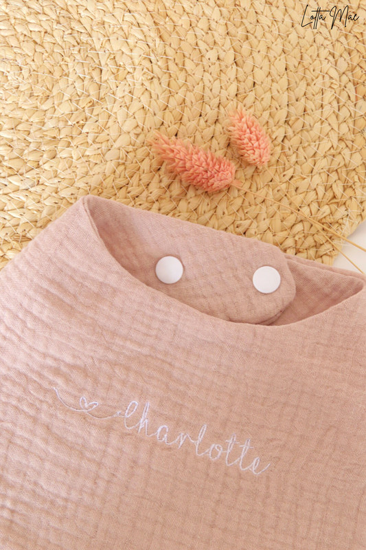 This baby bib is perfect for your little one! Made from 100% cotton, it’s soft and comfortable against delicate skin. It can be embroidered with a name or word of your choice in a variety of fonts and colors to create a personalized look. Plus, the snap buttons make it easy to put on and take off - no more struggling with ties! It’s perfect for everyday use, or an extra special occasion. 
Keep your baby clean and looking great in this stylish bib. Get yours today!