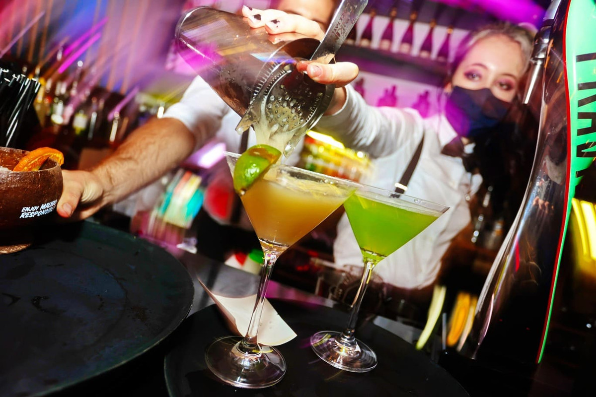 Bartender is making alcoholic drink in a party at Dorothys