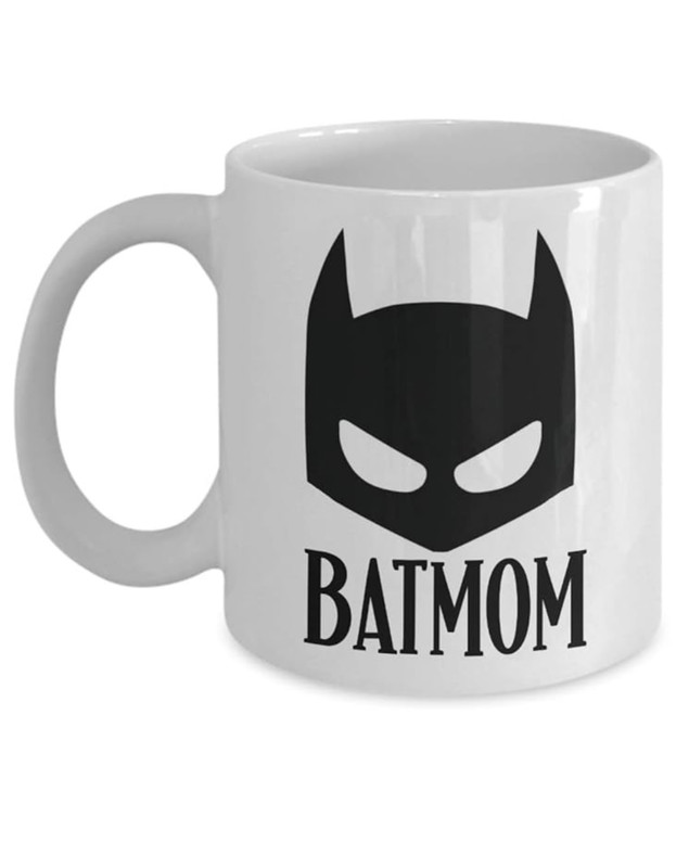 White ceramic mug with a drawing of Batman’s cowl and the words “Bat-Mom” under it