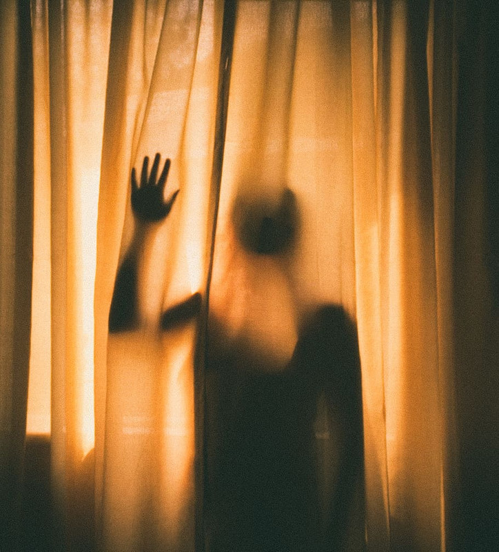 person-curtain-orange-light