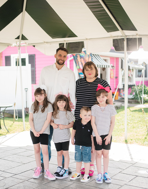Rebecca Boutin and family in matching striped shirts outside the bakery