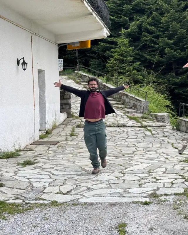 Apostolis walking down the path with his belly out