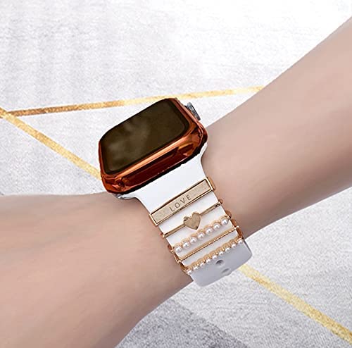 Una correa de reloj inteligente con varios anillos decorativos de metal, algunos con diamantes de imitación.