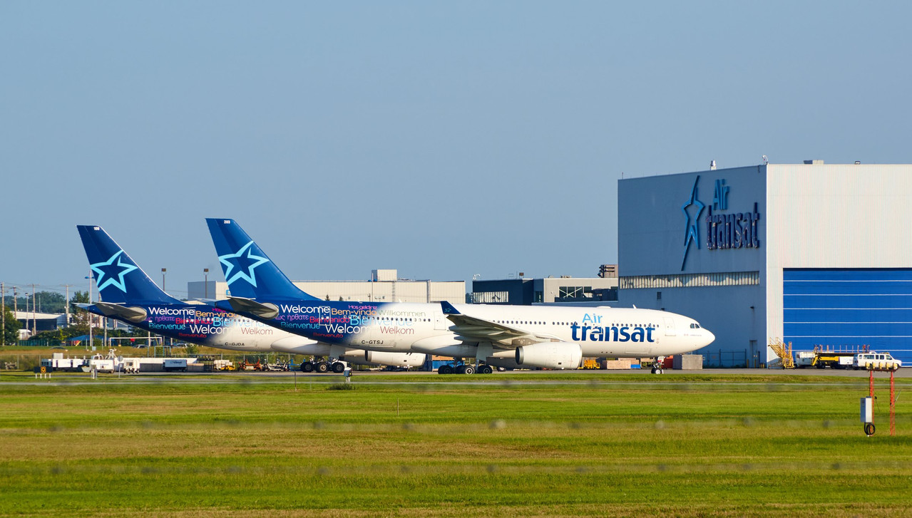 Air Transat aircraft in front of an Air Transat maintenance hangar