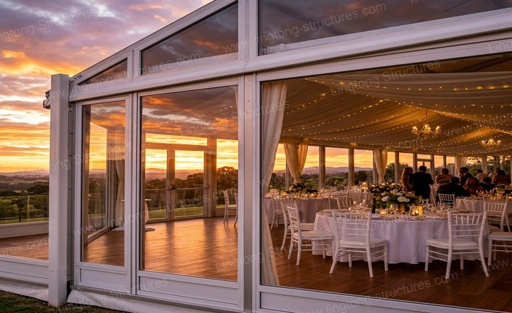 Interior of the wedding marquee showing the clear-span space with banquet tables and elegant lighting