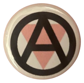 a white pin with the black anarchist 'A' symbol laid over an upside down pink triangle