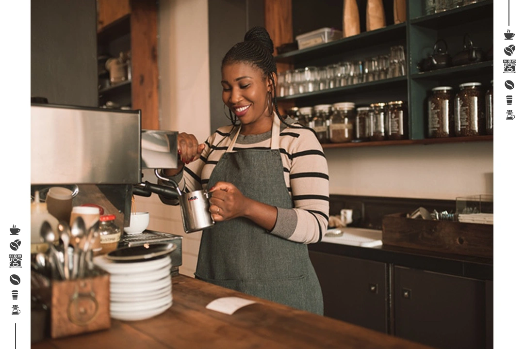 Smiling barista steaming milk coffee