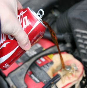 Pouring cola over a corroded battery terminal