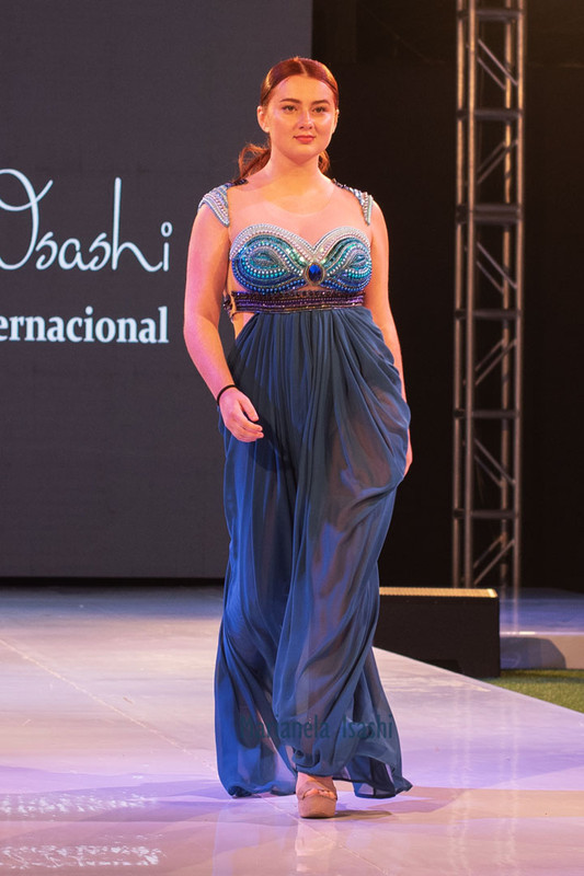 Long evening dress in turquoise with sweetheart neckline, bare shoulders and embroidery details in rhinestones.
