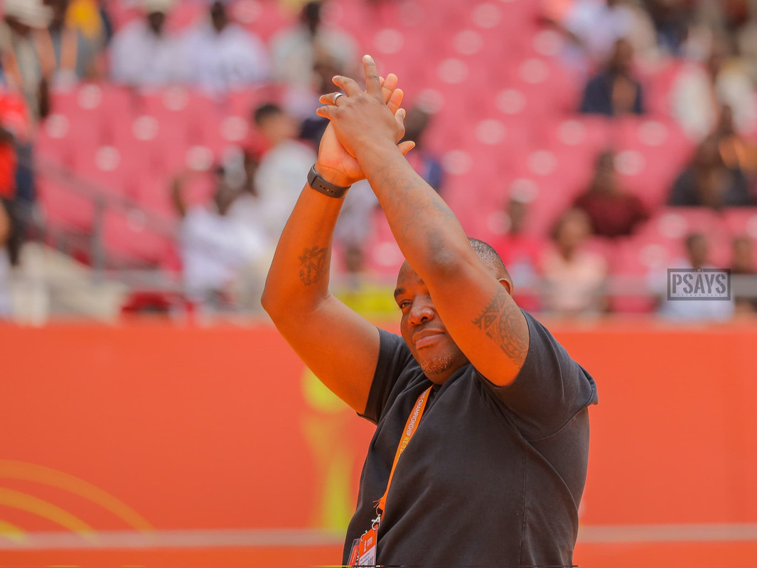 Football coach cheering with team after victory