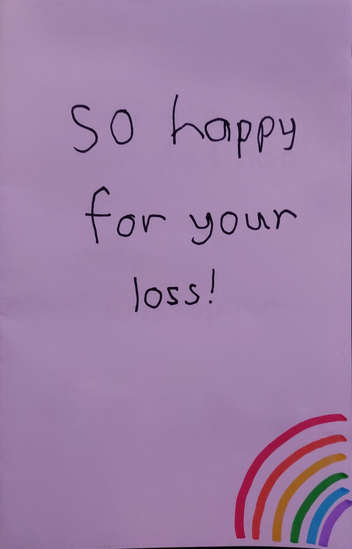 A white paper card that reads, ‘so happy for your loss!’ with a rainbow in the corner.