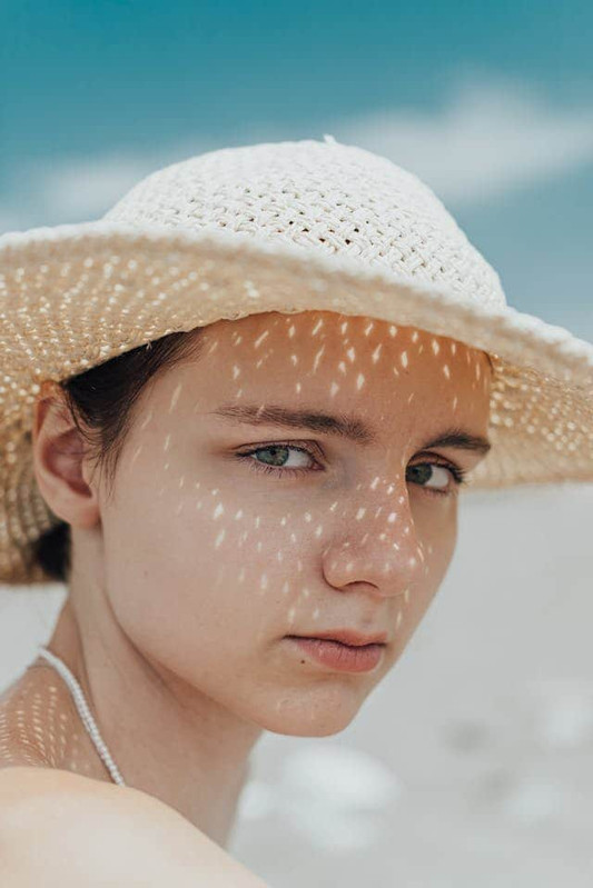 a girl wearing hat to protect her skin barrier from sunlight and UV rays 