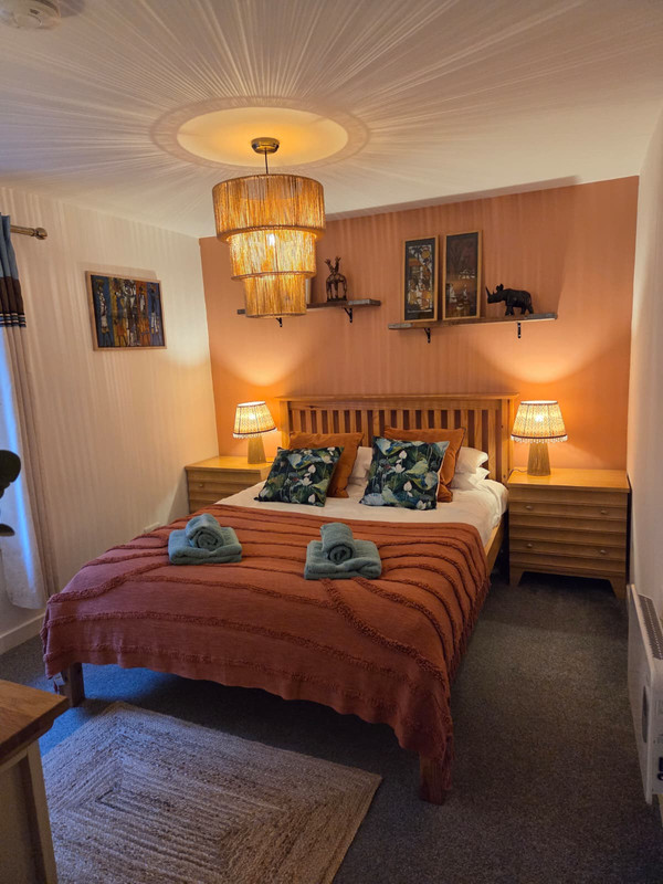 King bedroom with warm rust tones