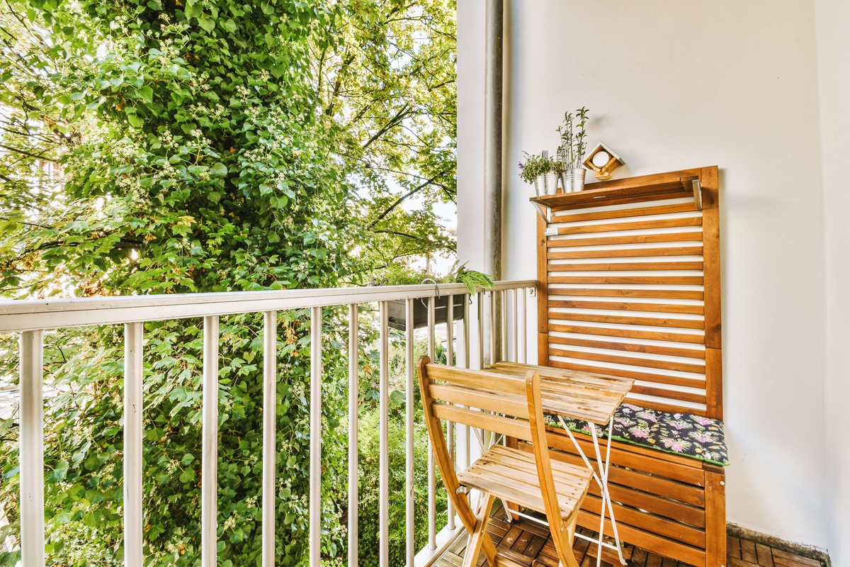 Modern Balcony Design with Wooden Slats, Vertical Garden, and Wicker Chair