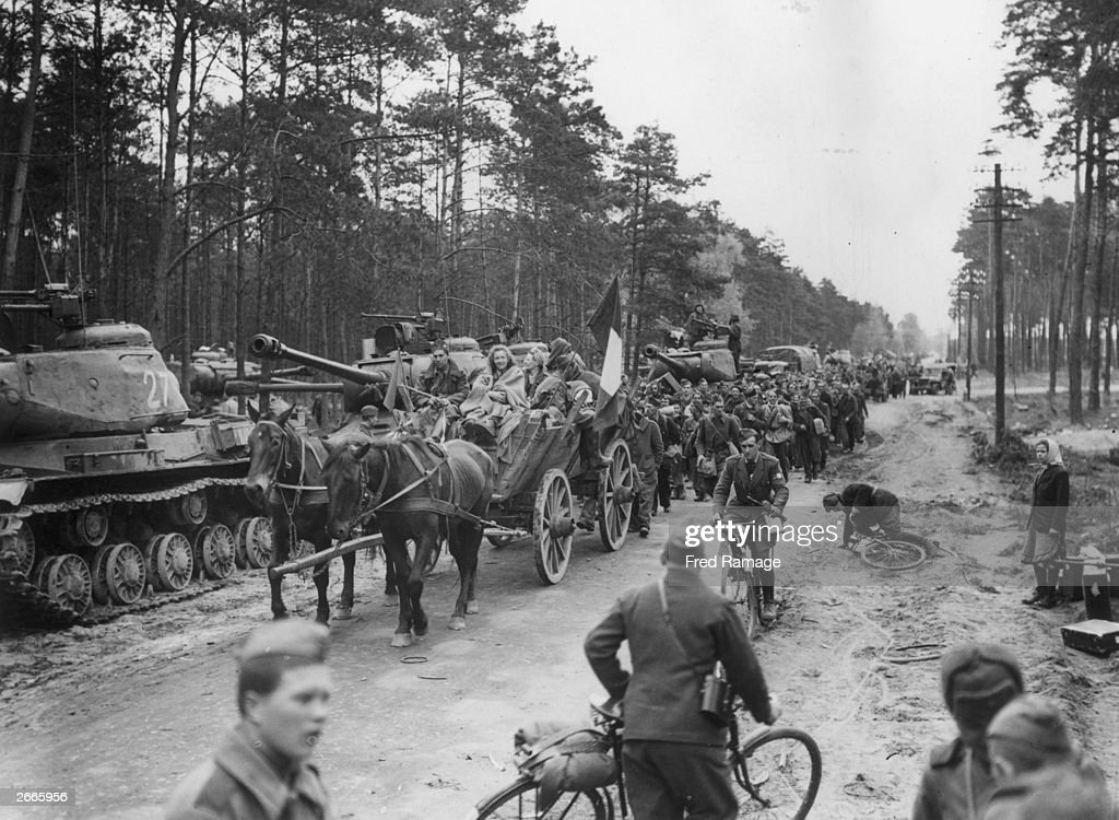 On a road west of Berlin and flanked by Russian Red Army IS-2JS-2 (Josef Stalin) Heavy tanks, former