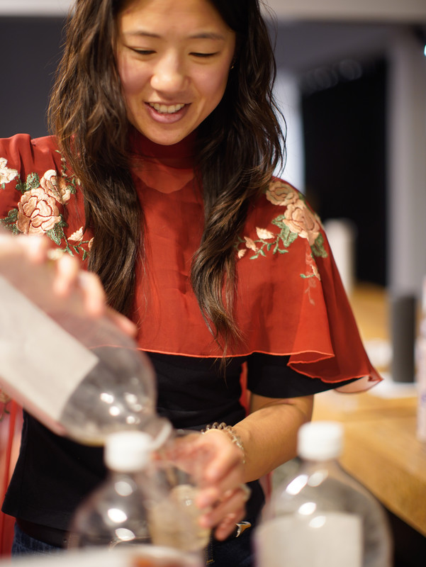 Sabrina Long pours traditional chinese medicine inspired beverages during the opening