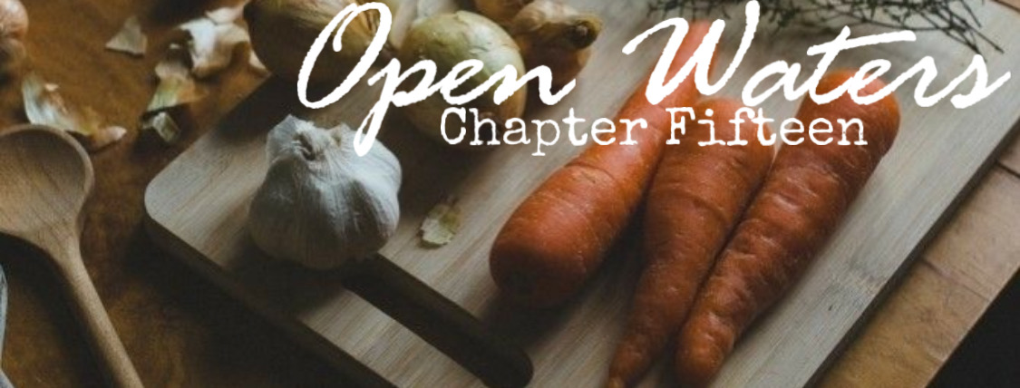 Chapter fifteen: Carrots and garlic and onions on a cutting board. 