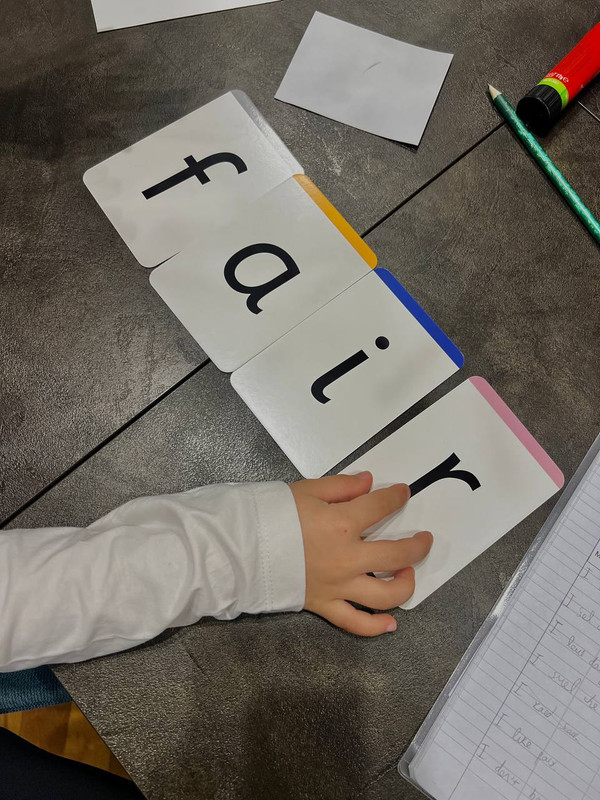 Yeg smiling with a young learner