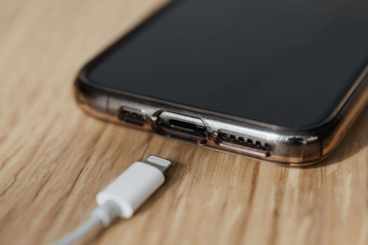 Smartphone charging overnight on bedside table