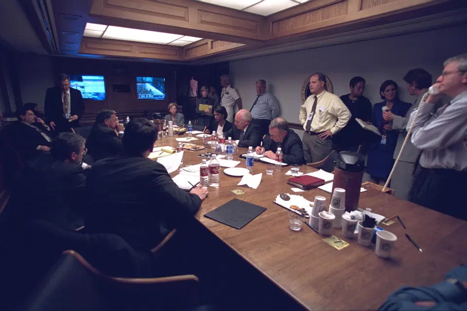 Vice President Dick Cheney and National Security Advisor Condoleezza Rice meet with staff inside the PEOC after September 11 attack