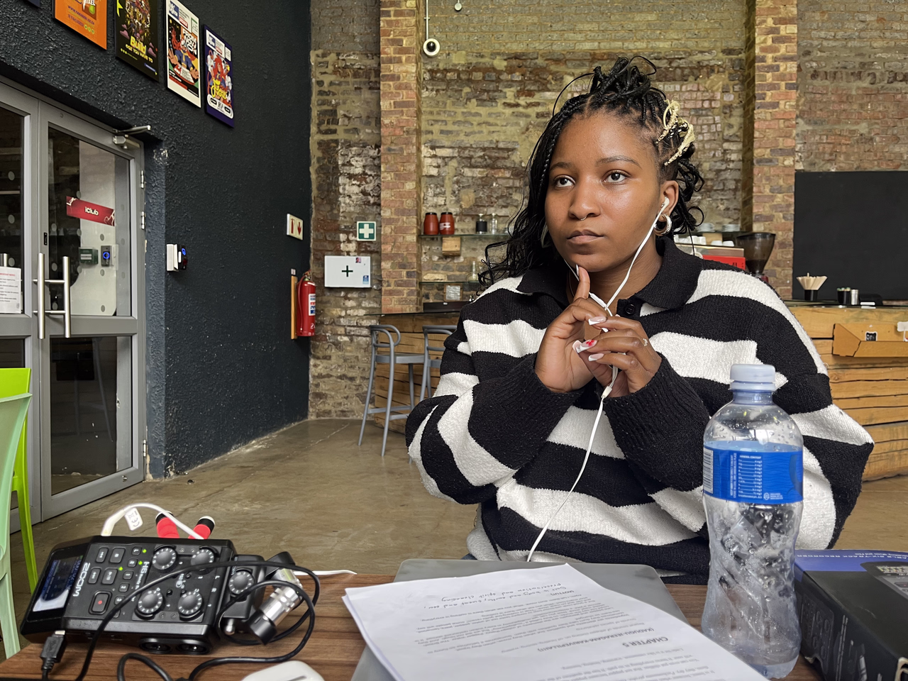 Samukelisiwe Dube recording sound and wearing headphones