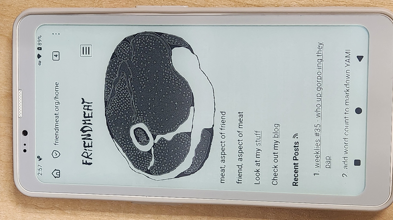 photo of an e-ink phone displaying the homepage from friendmeat.org