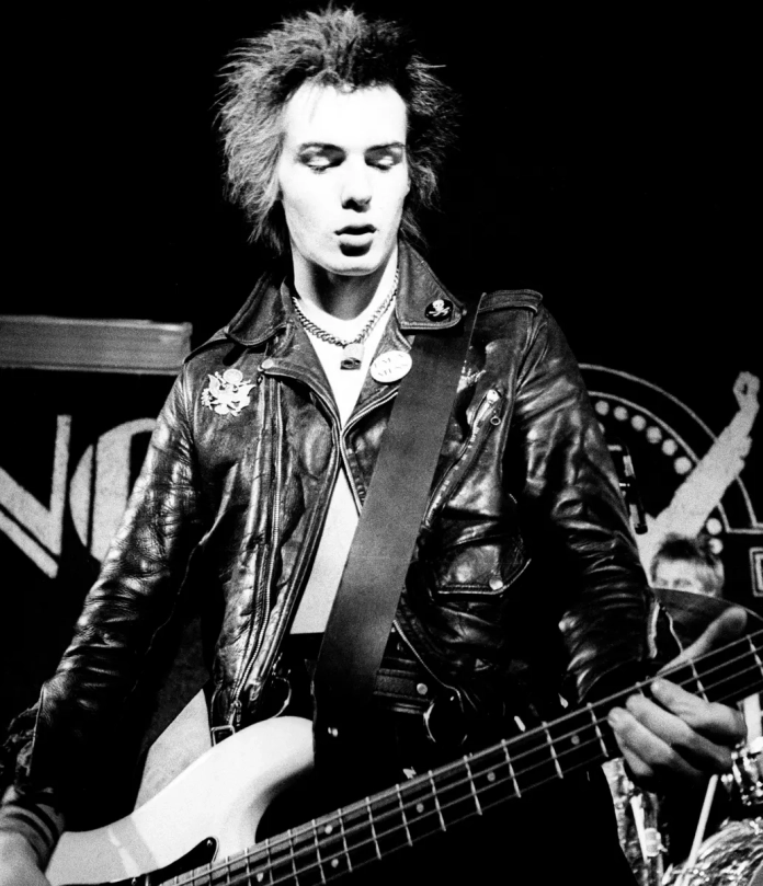 Sid Vicious hair style on stage while playing bass guitar