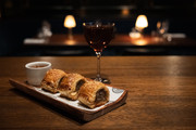 Sausage roll with manhattan cocktail