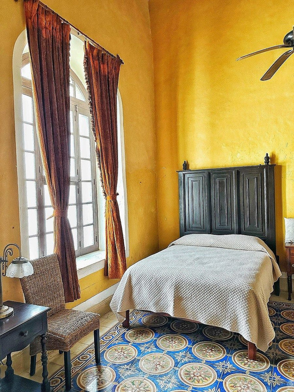 Bedroom with original pasta tile floors at Villa Sofía