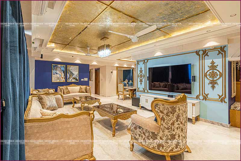 A living room with gold furniture and blue curtains.