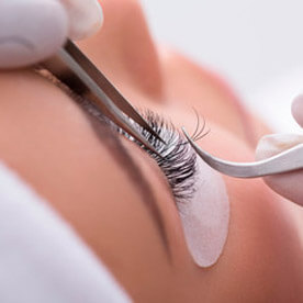 Woman with perfect eyelash extensions smiling.