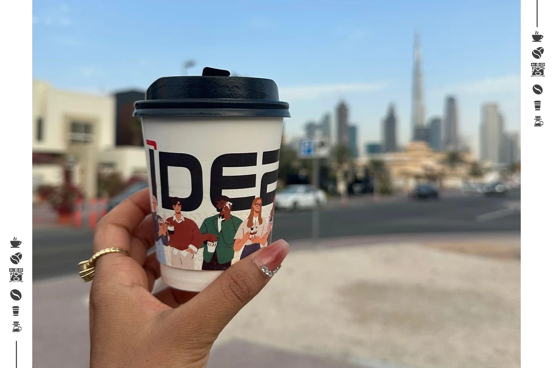 Hand holding espresso coffee cup