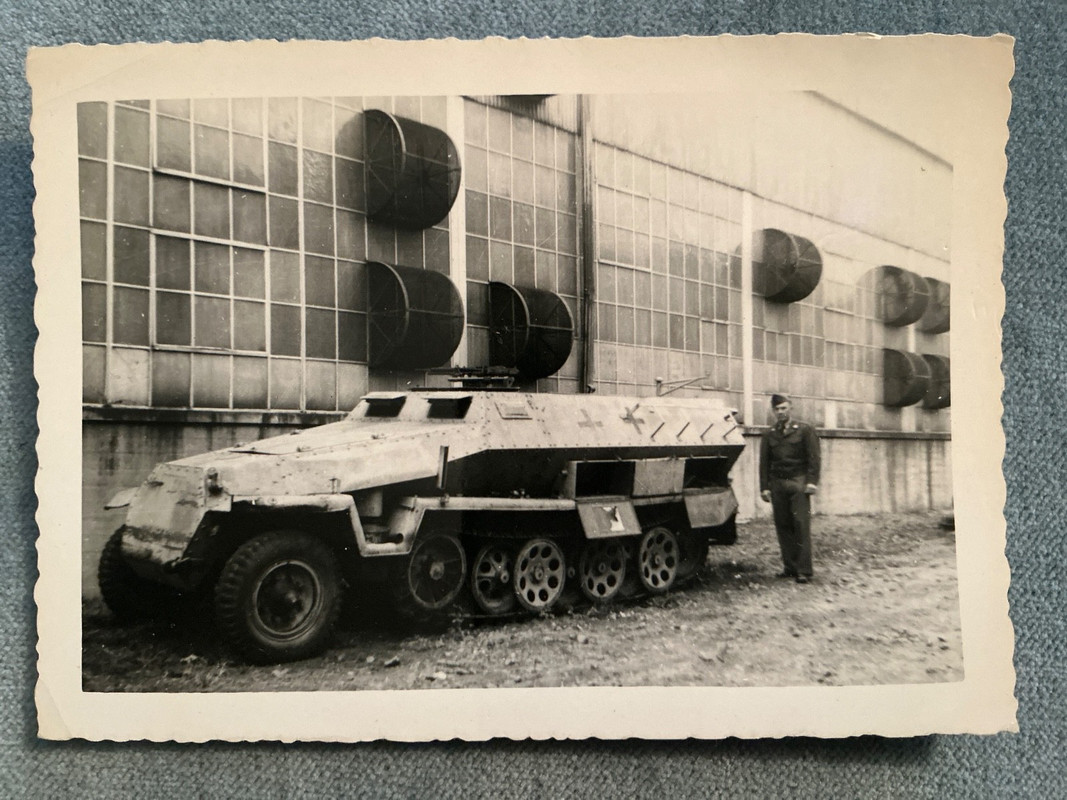 GI posing next to German armored half track vehicle (1)