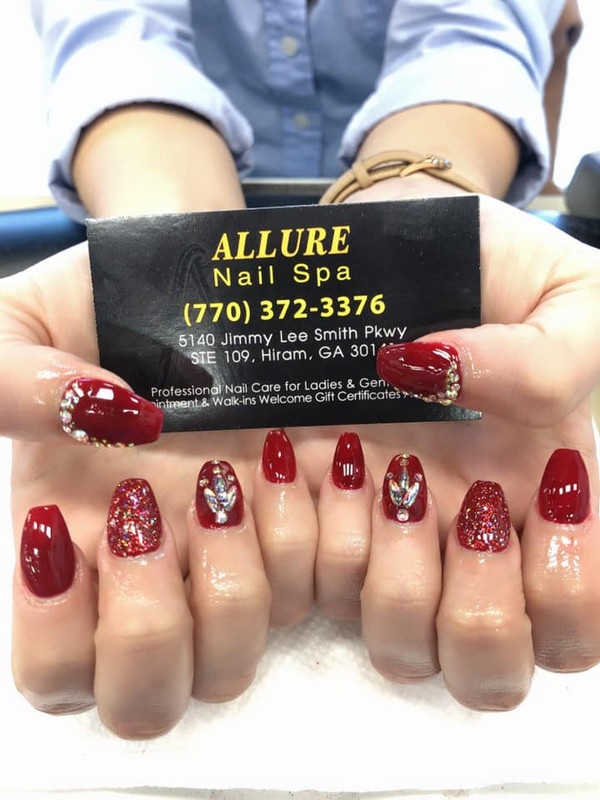 Red glitter nails with decorative gems