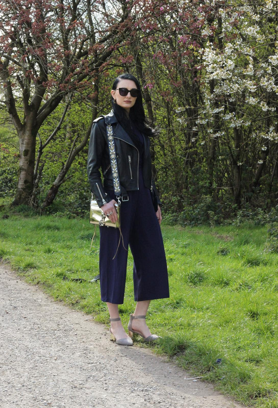 Spring fashion look navy jumpsuit leather jacket