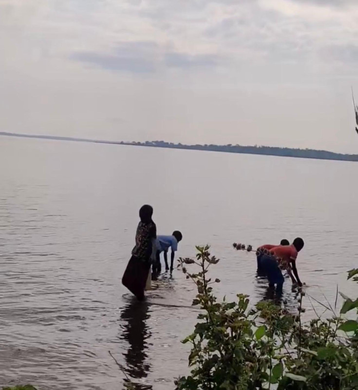 People collecting lake water