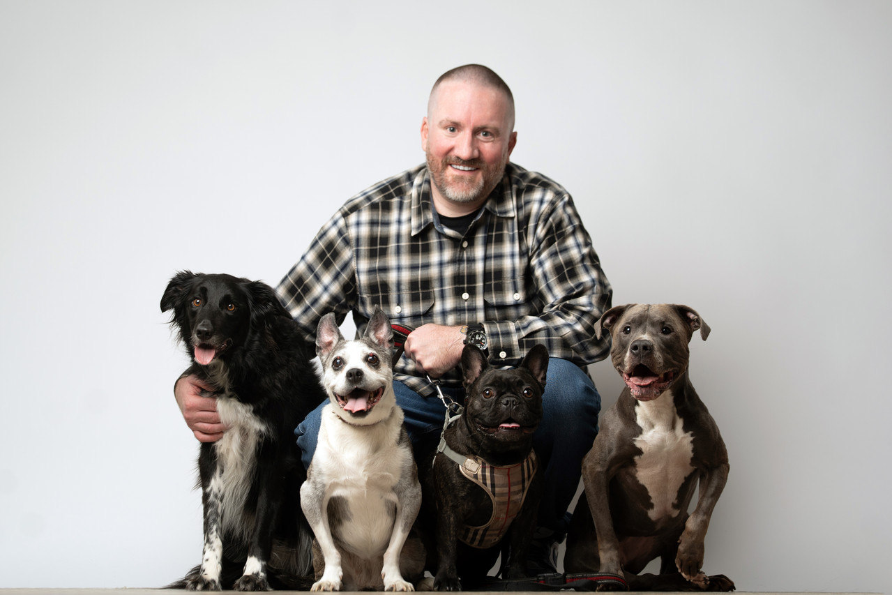 Sean Wallace with four dogs from West End Dog Crew