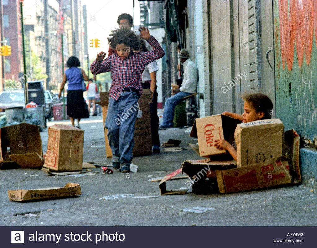 poor-children-playing-with-cartoons-new-york-usa-AYY4W3