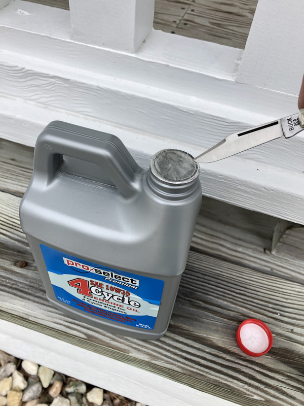 Buck-303-cutting-seal-on-oil-can.jpg