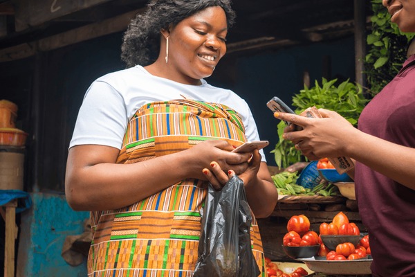 Ugandan woman selling at local market using LivePay payment links