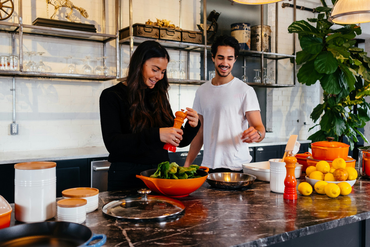 Couple-cooking-together-in-a-cozy-kitchen-preparing-a-new-recipe