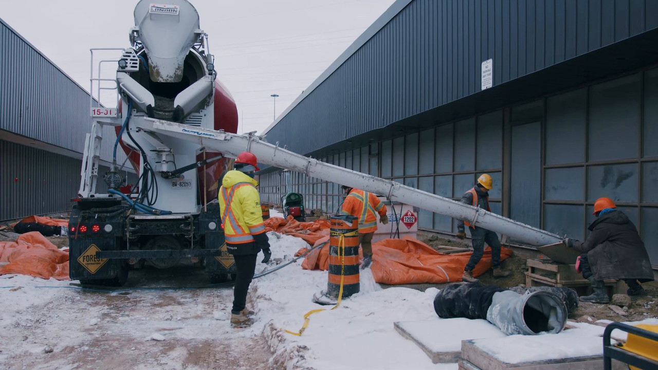 Crew placing concrete in winter conditions at the TWI Foods expansion