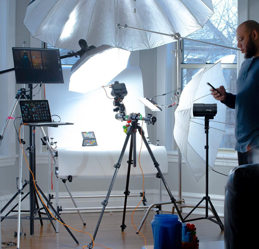 Andrew Harris in a Chicago product photography studio with lighting, camera, tethered laptop, and product table setup