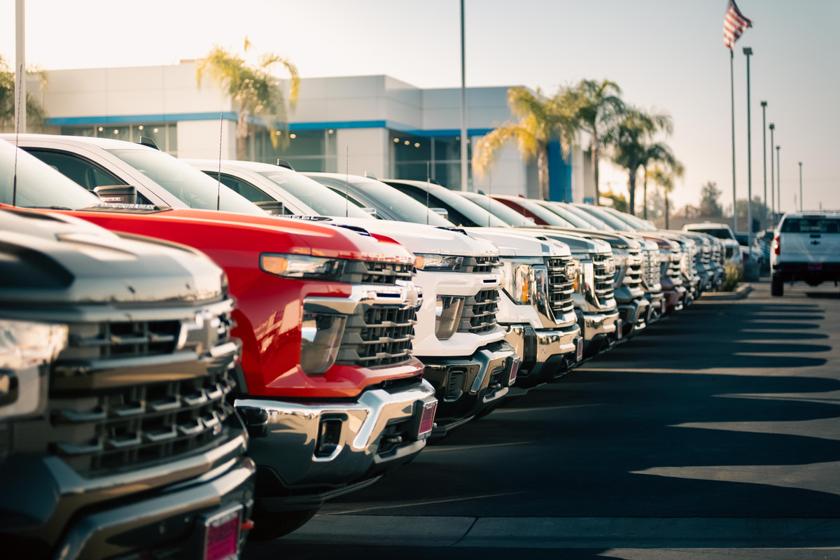 Exterior image of Ed Dena's Auto Center with a line up of trucks.