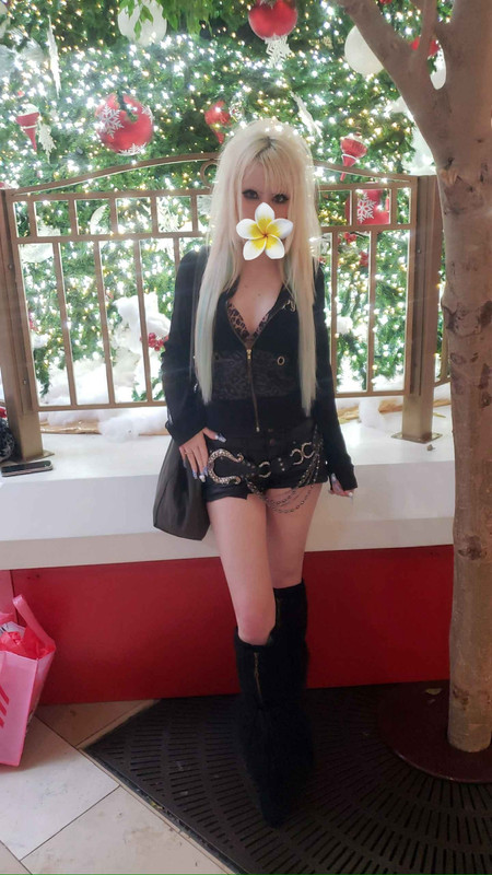 Ray with teased hair in a black outfit.
