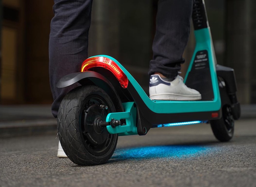 Lifestyle product photography of an electric scooter rear wheel and rider in Chicago