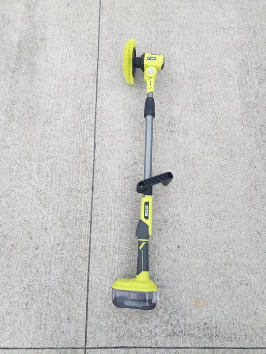 Telescoping power scrubber cleaning a bathroom surface