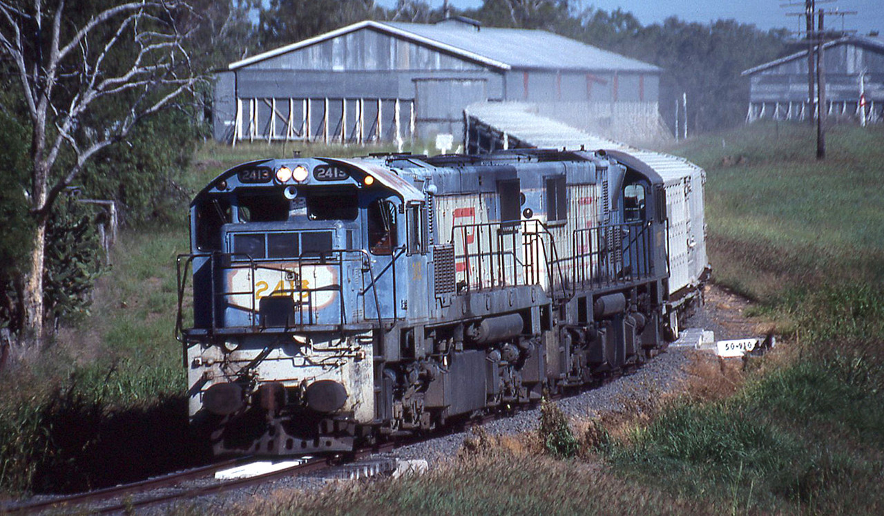 Heading for Wandoan, empty livestock train 6L42 passes through Guluguba with 2413 2197F leading 13 K
