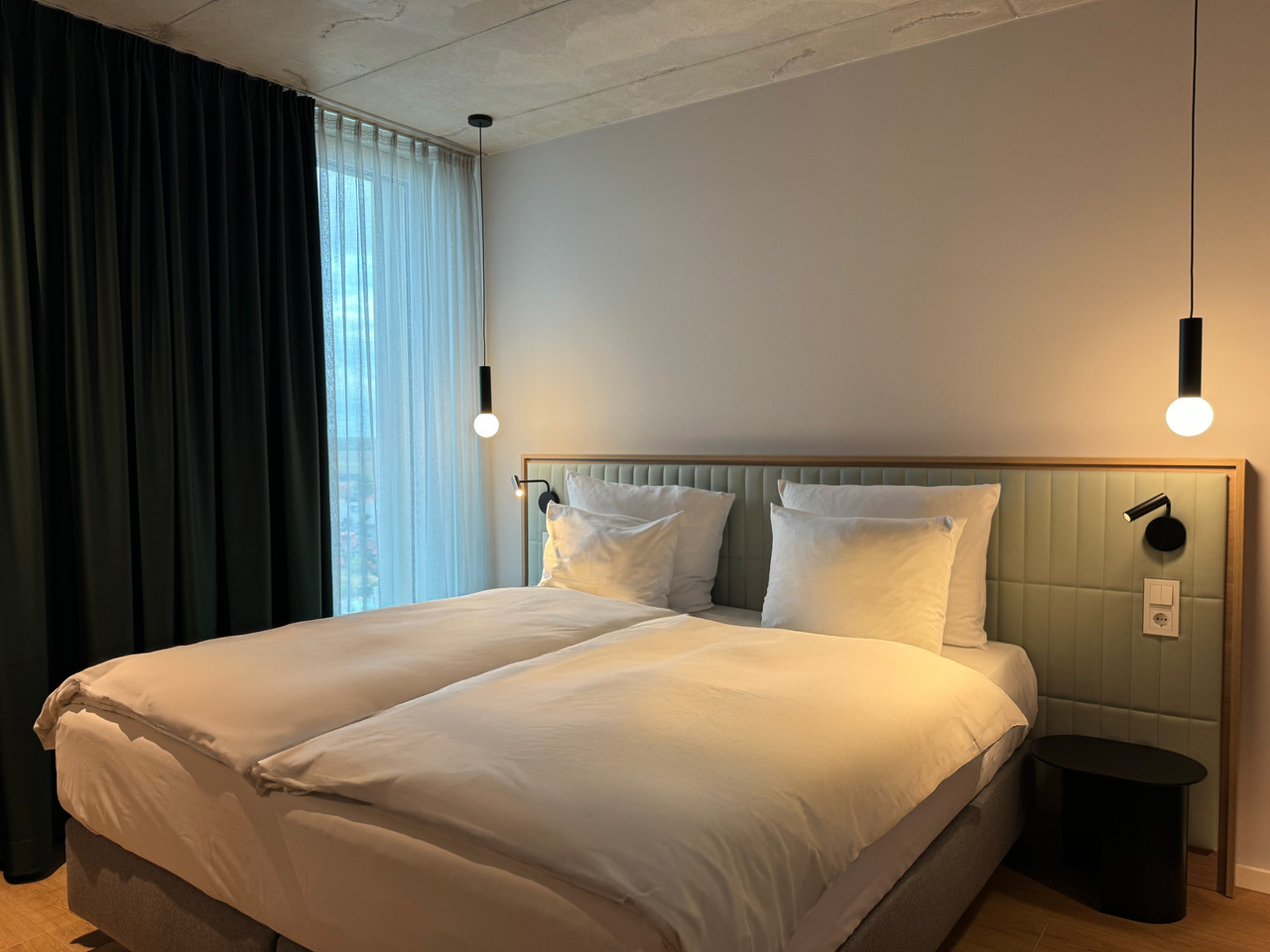 Modern guest room lighting at Coreum Hotel with warm bedside light and restrained architectural illumination