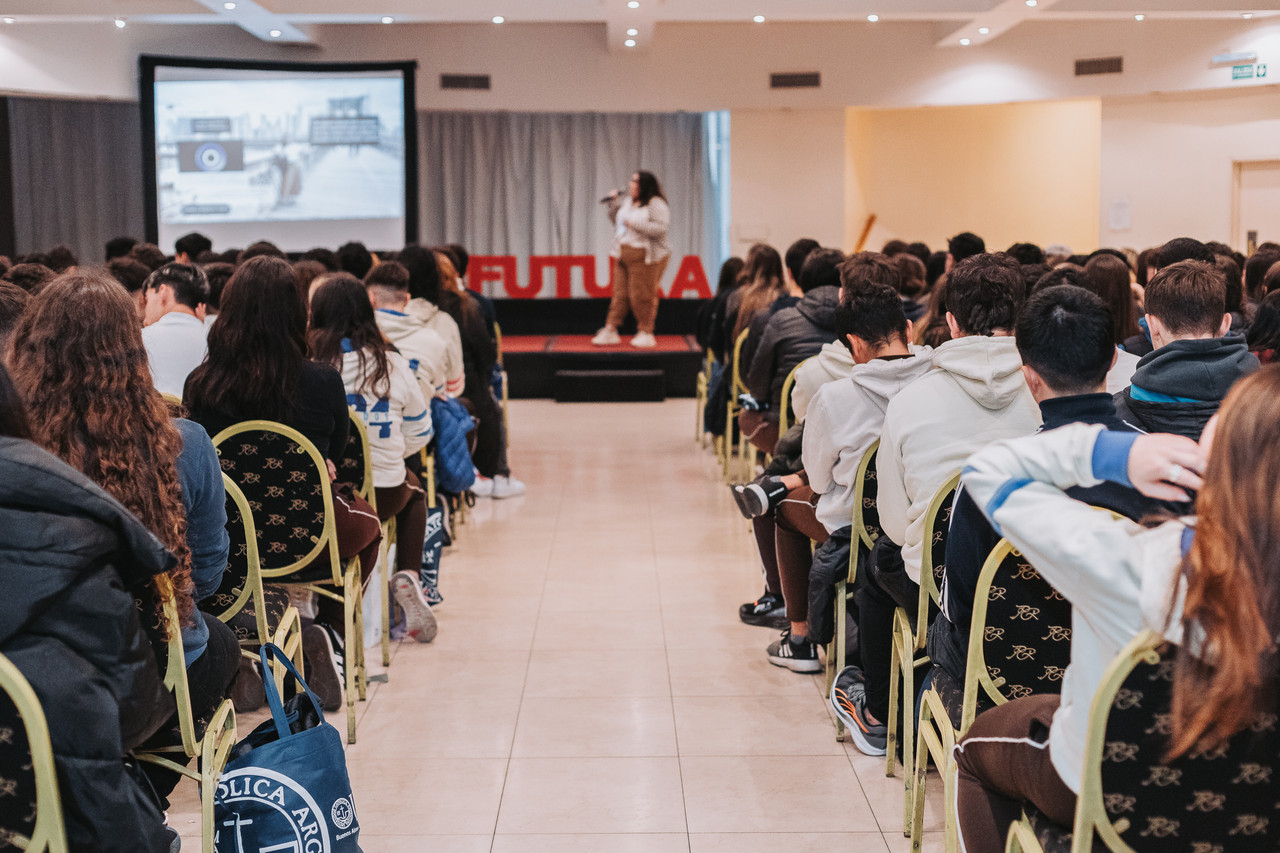 A presenter on a stage at an event.